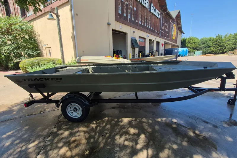 Slide: The Image of 2026 Tracker Grizzly 1754 Utility boat on trailer outside showroom. - 4
