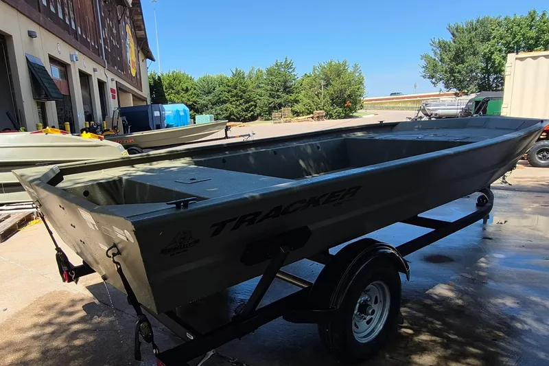 Slide: The Image of 2026 Tracker Grizzly 1754 Utility boat on trailer, parked outdoors near a building. - 5