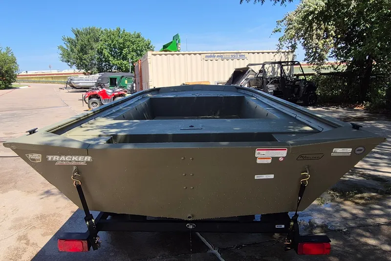 Slide: The Image of 2026 Tracker Grizzly 1754 Utility boat on trailer, parked outdoors under clear sky. - 6