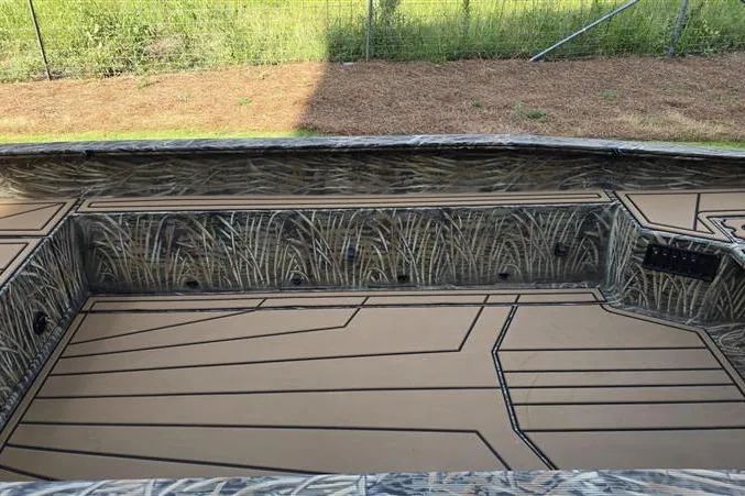 Slide: The Image of 2026 Tracker Grizzly 1650 T Prairie Wings Edition boat interior with camouflage design. - 10