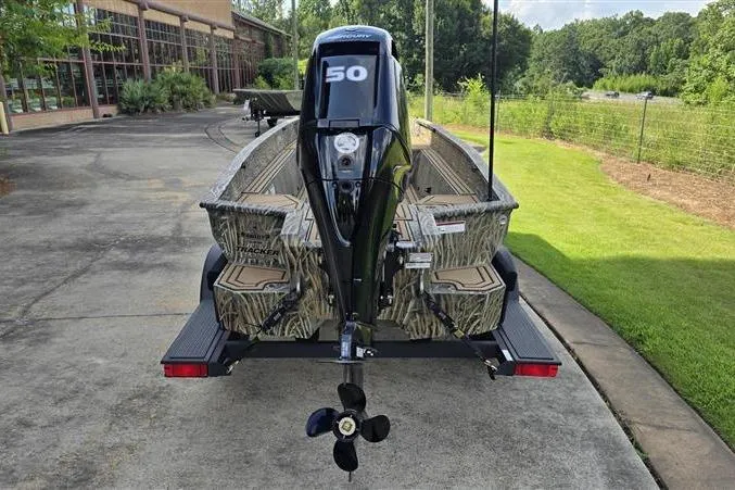 Slide: The Image of 2026 Tracker Grizzly 1650 T Prairie Wings Edition boat on trailer, rear view. - 5