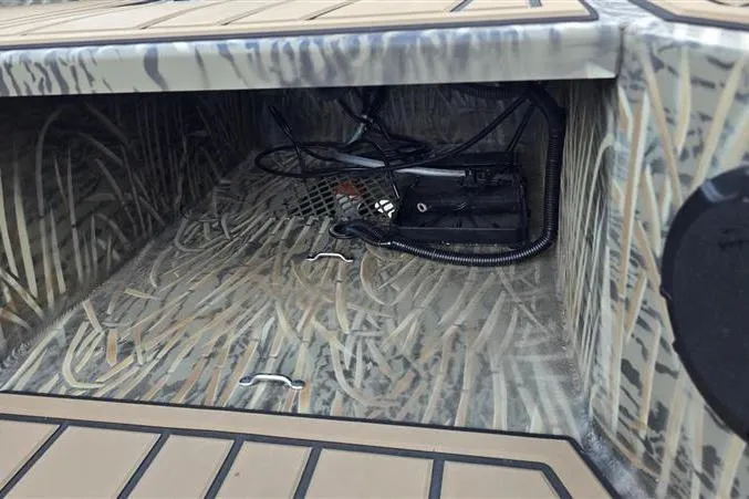 Slide: The Image of 2026 Tracker Grizzly 1650 T Prairie Wings Edition interior storage with camouflage design and wiring. - 9