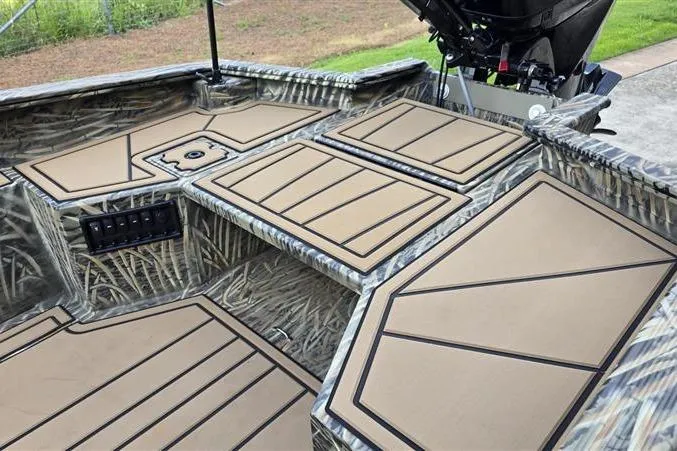 Slide: The Image of 2026 Tracker Grizzly 1650 T Prairie Wings Edition boat interior with camo design and padded surfaces. - 11