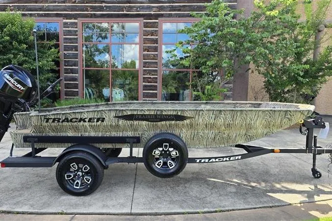 The Image of 2026 Tracker Grizzly 1650 T Prairie Wings Edition boat on trailer, camo design. - 0
