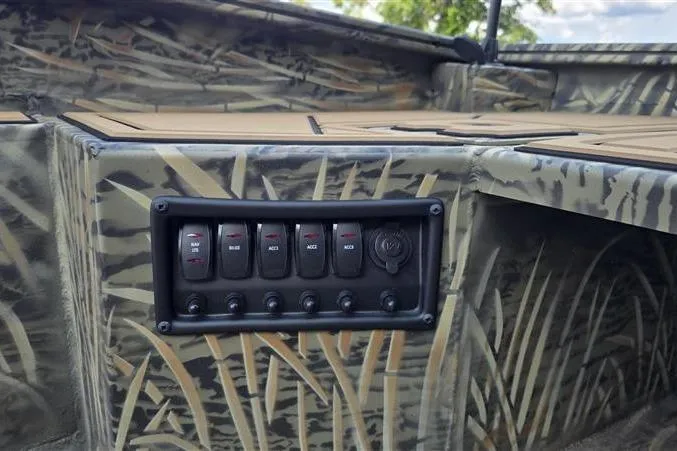 Slide: The Image of Control panel of 2026 Tracker Grizzly 1650 T Prairie Wings Edition boat with camouflage design. - 7