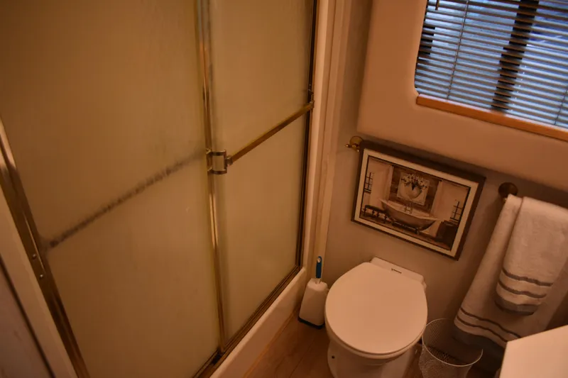 Slide: The Image of Bathroom interior of 1996 Stardust Cruisers houseboat with shower, toilet, and decor. - 17