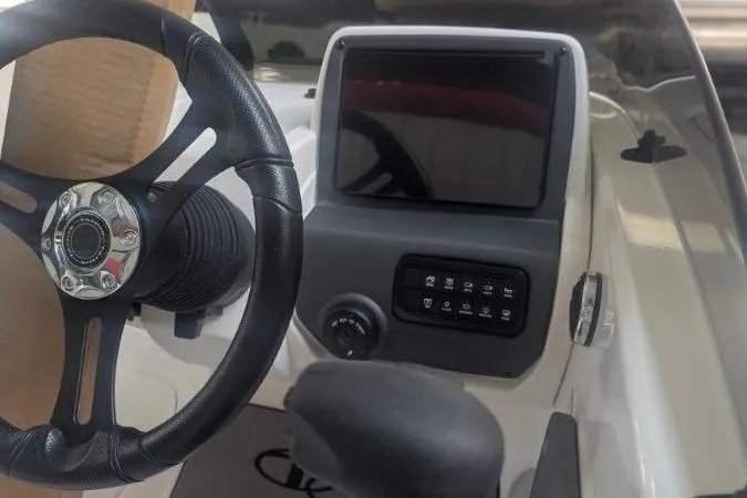 Slide: The Image of Steering wheel and dashboard of 2026 Tahoe T21 boat with touchscreen display. - 2