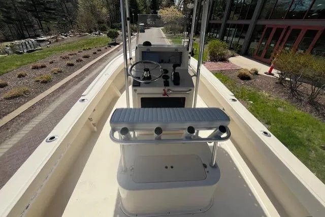 Slide: The Image of 2005 Parker 2100 Center Console boat with steering wheel and seating, docked outdoors. - 4