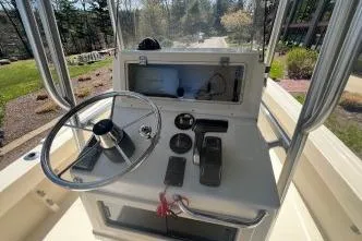 Slide: The Image of 2005 Parker 2100 Center Console boat dashboard with steering wheel and controls. - 5