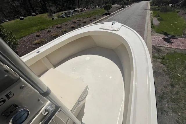 Slide: The Image of 2005 Parker 2100 Center Console boat on a paved road, surrounded by greenery. - 6