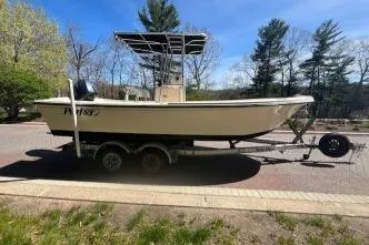 Slide: The Image of 2005 Parker 2100 Center Console boat on trailer, parked outdoors, surrounded by trees. - 9