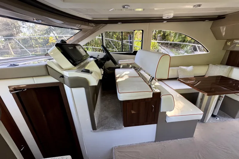 Slide: The Image of Interior of 2015 Carver 40 Command Bridge with helm and seating area. - 4