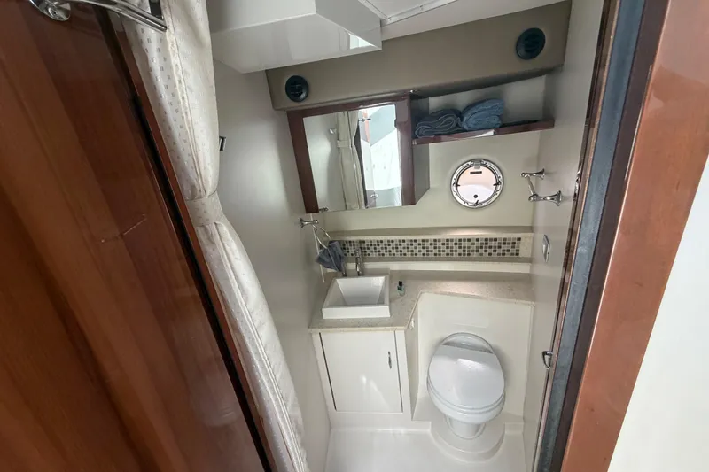 Slide: The Image of Bathroom interior of 2015 Carver 40 Command Bridge yacht, featuring sink, toilet, and porthole. - 41