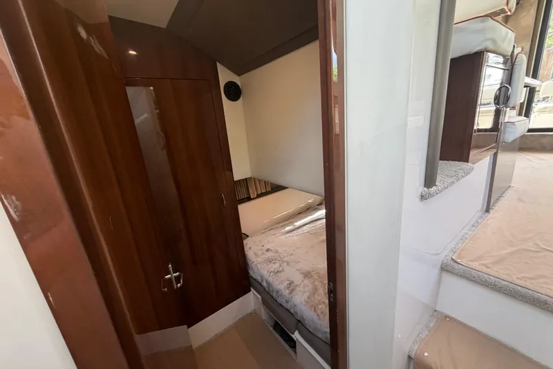 Slide: The Image of Interior cabin of 2015 Carver 40 Command Bridge yacht, featuring cozy sleeping area and wooden finishes. - 43
