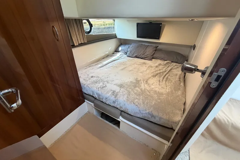 Slide: The Image of Cozy bedroom in 2015 Carver 40 Command Bridge yacht with plush bedding and TV. - 44