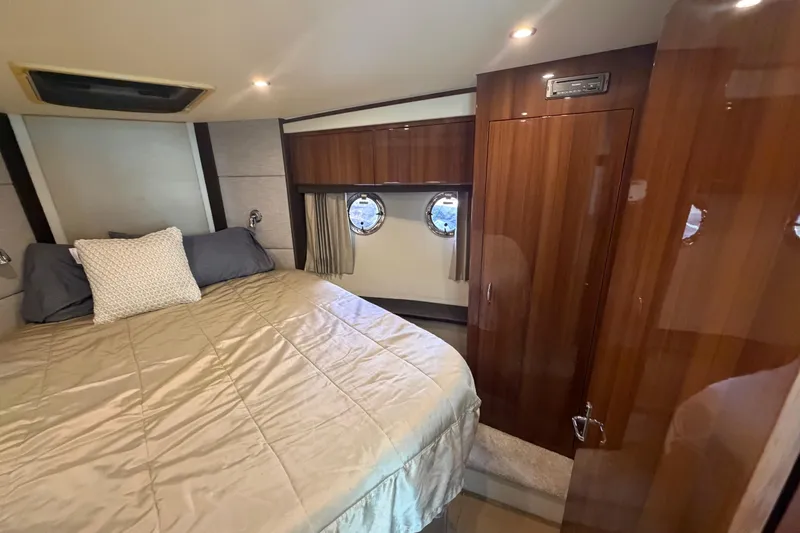 Slide: The Image of Luxurious bedroom interior of 2015 Carver 40 Command Bridge yacht with wood finishes. - 46