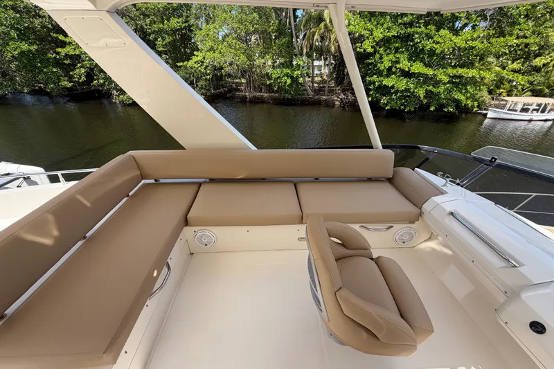 Slide: The Image of Luxurious seating area on 2015 Carver 40 Command Bridge yacht, overlooking serene waterway. - 49