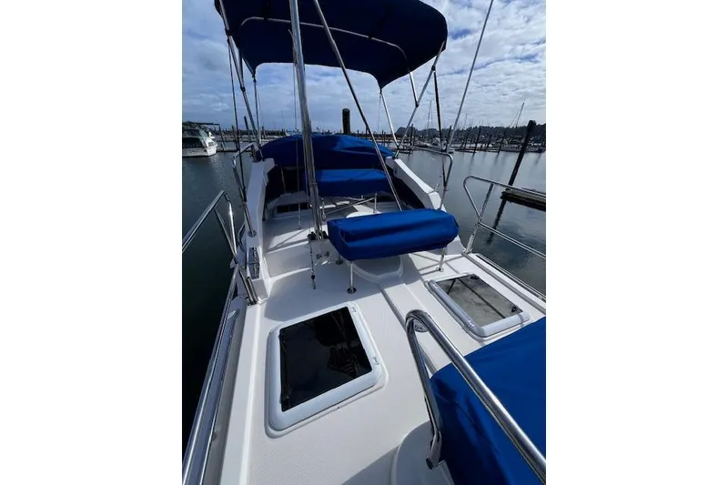 Slide: The Image of 2021 Ranger Tugs R-31 CB boat deck with blue seating and canopy. - 11