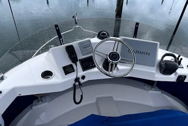 Slide: The Image of Cockpit of 2021 Ranger Tugs R-31 CB with Garmin navigation system and steering wheel. - 12