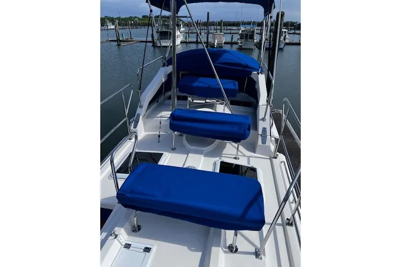 Slide: The Image of 2021 Ranger Tugs R-31 CB boat deck with blue seating, docked at marina. - 14