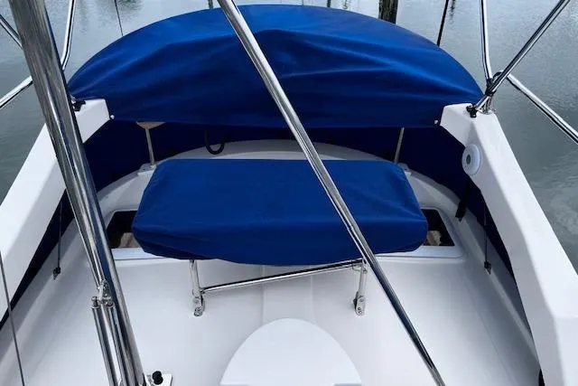 Slide: The Image of 2021 Ranger Tugs R-31 CB boat with blue seating and canopy on deck. - 15