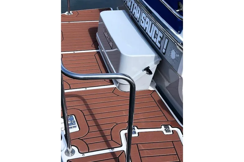 Slide: The Image of 2021 Ranger Tugs R-31 CB boat deck with wooden finish and storage box. - 25