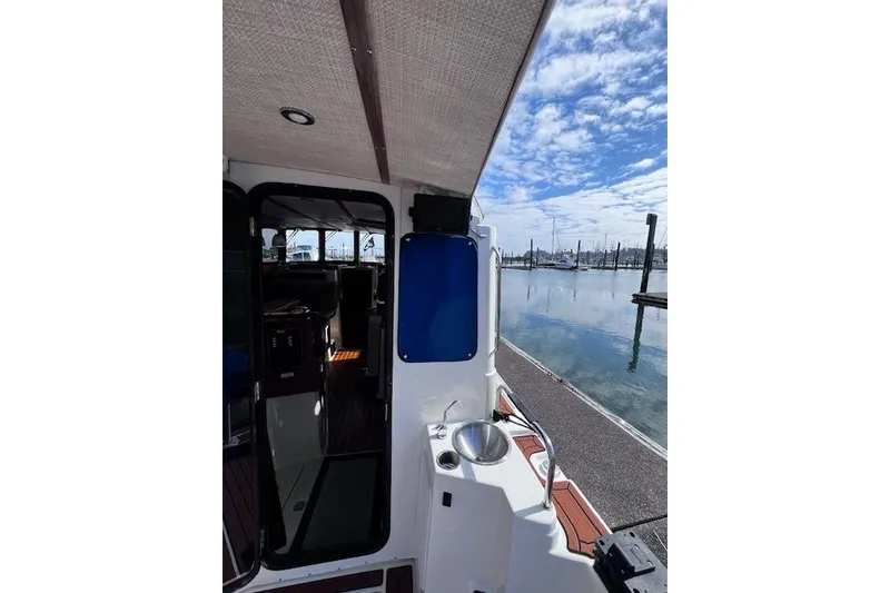 Slide: The Image of 2021 Ranger Tugs R-31 CB boat interior with dockside view and clear sky. - 28