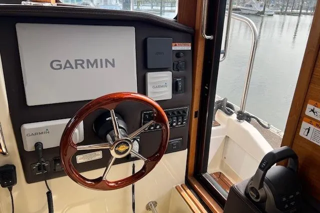 Slide: The Image of 2021 Ranger Tugs R-31 CB helm with Garmin navigation system and wooden steering wheel. - 37