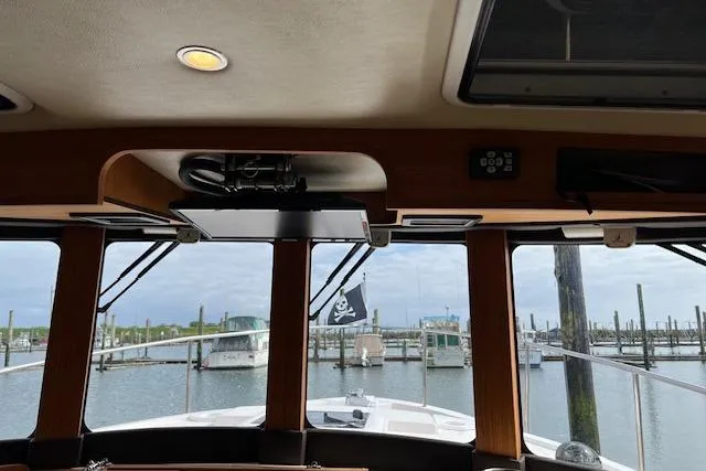 Slide: The Image of Interior view from a 2021 Ranger Tugs R-31 CB, overlooking a marina with boats. - 38