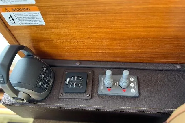 Slide: The Image of Control panel of 2021 Ranger Tugs R-31 CB boat with joysticks and switches. - 39