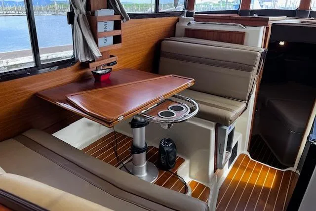 Slide: The Image of Interior of 2021 Ranger Tugs R-31 CB with wood accents and seating area. - 40