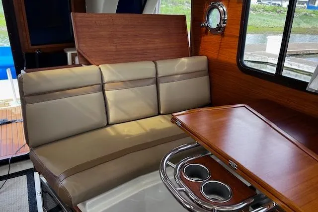 Slide: The Image of Interior of 2021 Ranger Tugs R-31 CB with beige seating and wooden table. - 41