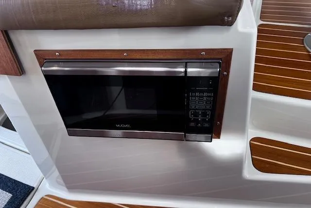 Slide: The Image of Built-in microwave on 2021 Ranger Tugs R-31 CB boat with wood paneling. - 47