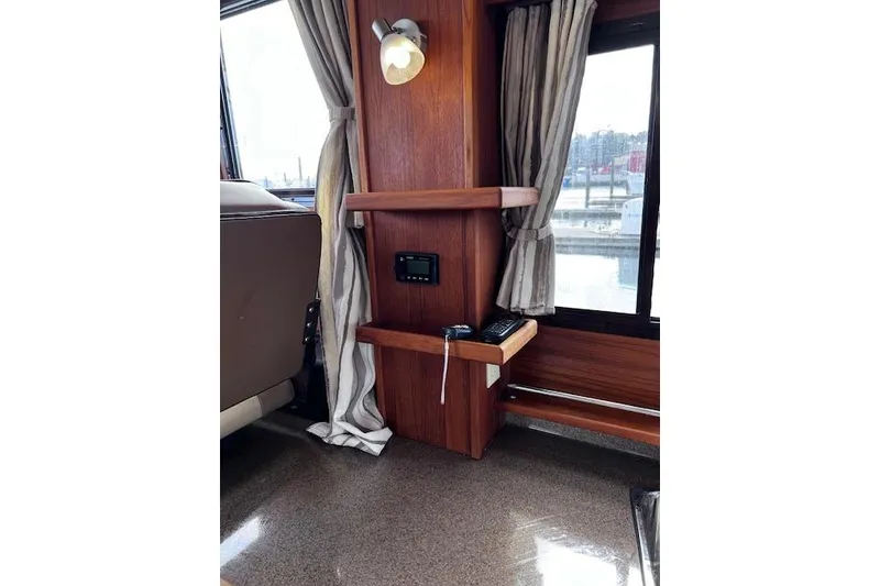 Slide: The Image of Interior of 2021 Ranger Tugs R-31 CB with wood paneling and window view. - 48