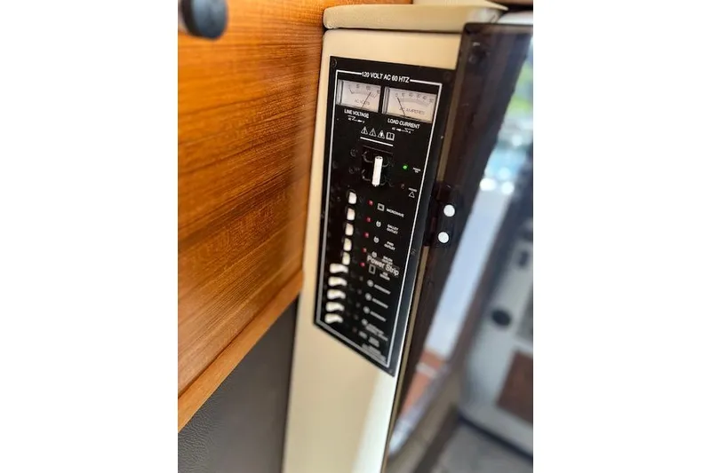 Slide: The Image of Control panel of 2021 Ranger Tugs R-31 CB boat, featuring voltage and current meters. - 50