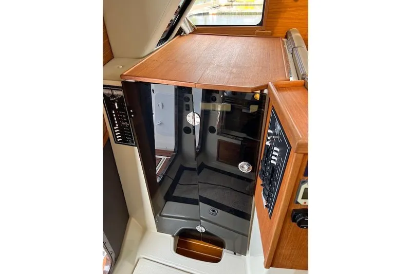 Slide: The Image of Interior view of 2021 Ranger Tugs R-31 CB, featuring wooden cabinetry and control panels. - 51