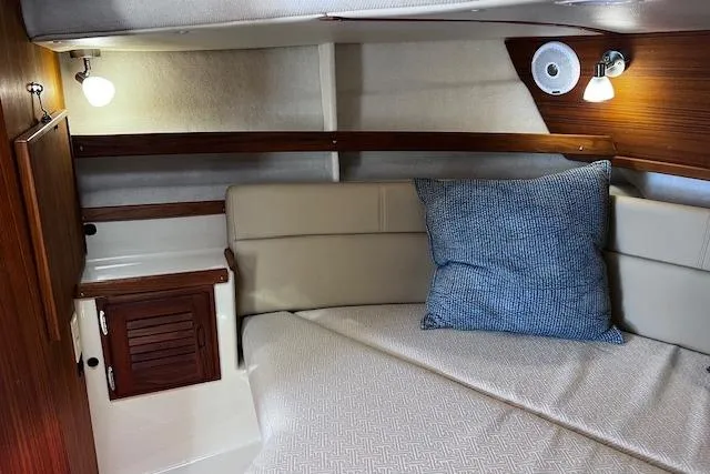 Slide: The Image of Cozy cabin interior of 2021 Ranger Tugs R-31 CB with plush bedding and ambient lighting. - 53
