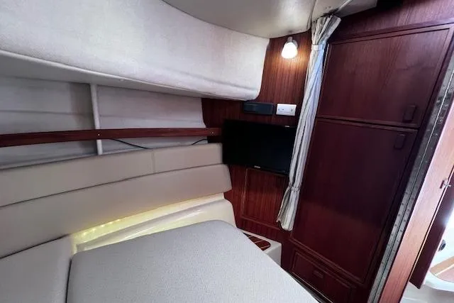 Slide: The Image of Interior cabin of 2021 Ranger Tugs R-31 CB with wood paneling and TV. - 54