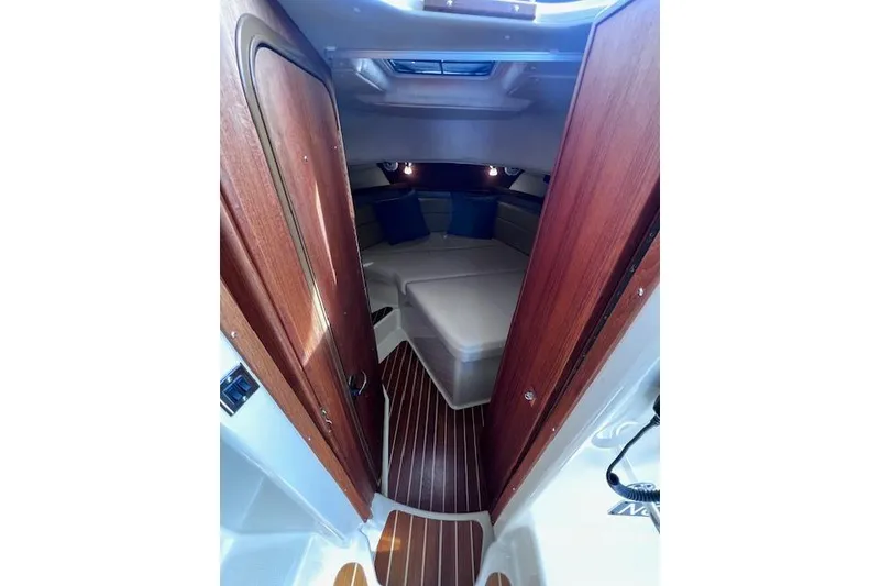 Slide: The Image of 2021 Ranger Tugs R-31 CB cabin interior with wood finish and cozy sleeping area. - 55
