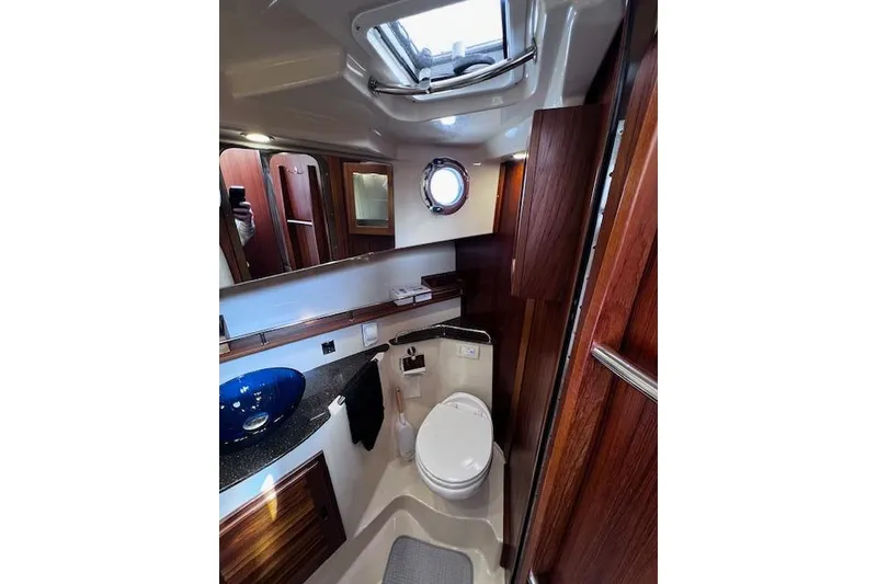 Slide: The Image of Luxurious bathroom interior of 2021 Ranger Tugs R-31 CB boat with wood accents. - 56