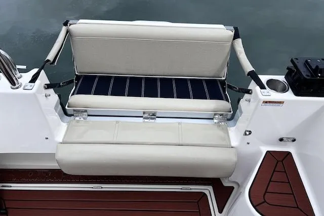 Slide: The Image of 2021 Ranger Tugs R-31 CB boat with cushioned seating and wooden deck details. - 61