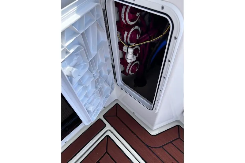 Slide: The Image of Open hatch on 2021 Ranger Tugs R-31 CB, revealing interior components and wiring. - 65
