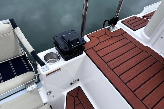 Slide: The Image of 2021 Ranger Tugs R-31 CB boat deck with wood finish and seating area. - 66