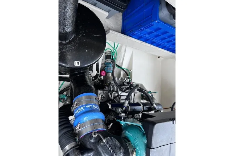Slide: The Image of Engine compartment of 2021 Ranger Tugs R-31 CB with visible hoses and components. - 71