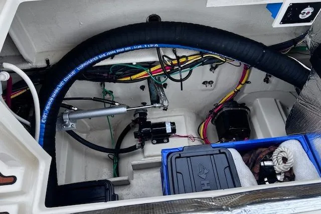 Slide: The Image of Engine compartment of a 2021 Ranger Tugs R-31 CB with visible wiring and components. - 75