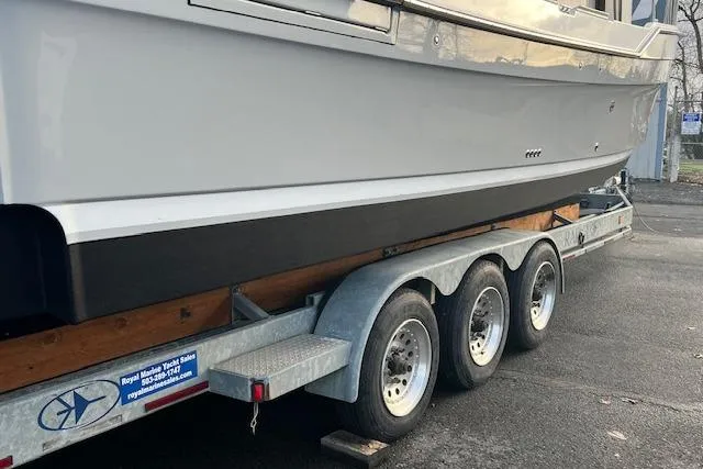 Slide: The Image of 2021 Ranger Tugs R-31 CB boat on a triple-axle trailer, parked outdoors. - 78