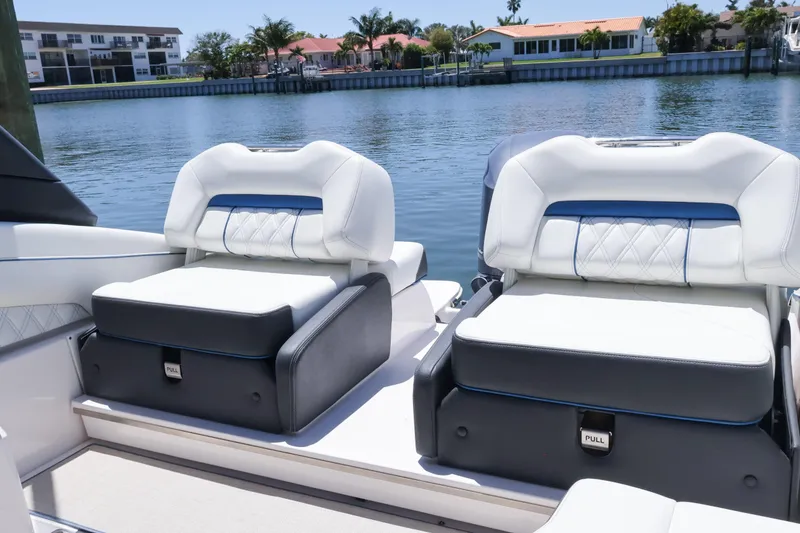 Slide: The Image of Luxury seating on 2020 Regal LX4 boat by waterfront homes. - 12