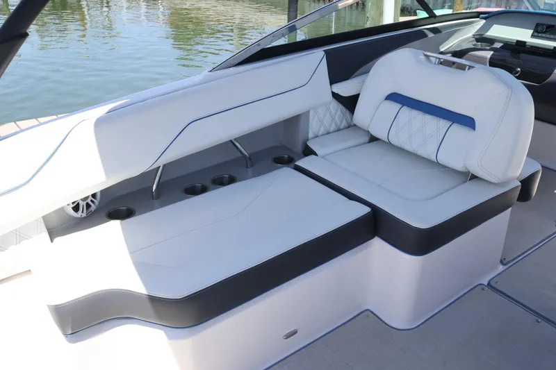Slide: The Image of Luxurious seating on a 2020 Regal LX4 boat, featuring white and blue upholstery. - 18