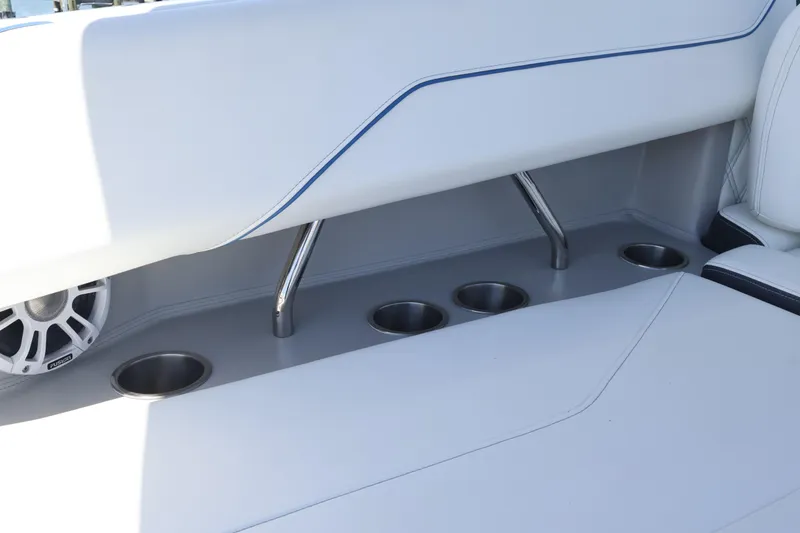 Slide: The Image of 2020 Regal LX4 boat interior with cup holders and speaker. - 19