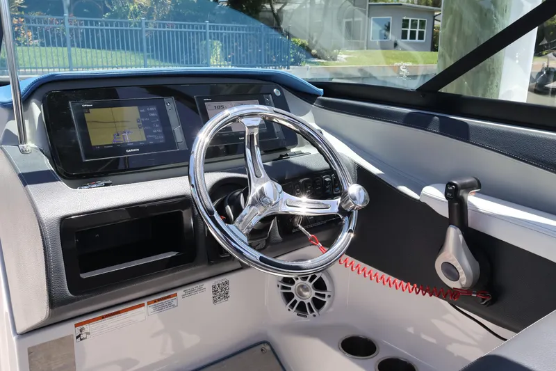 Slide: The Image of 2020 Regal LX4 boat dashboard with steering wheel and Garmin GPS display. - 22